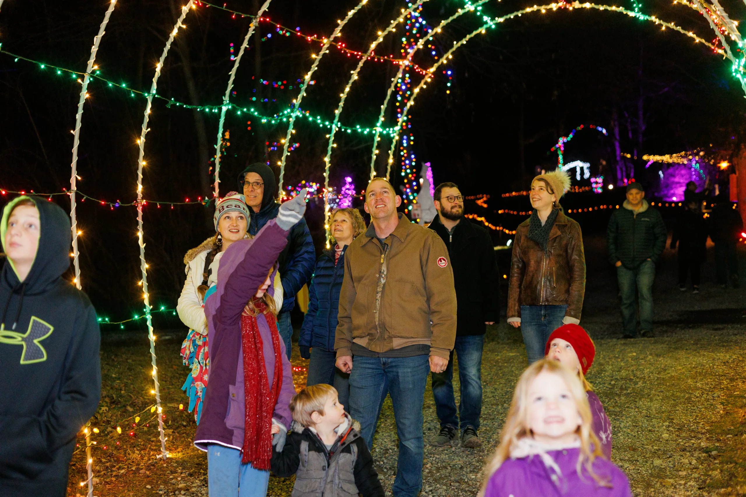 Christmas 2023 A Family Walking Through A Christmas Light Archway At Refreshing Mountain Retreat And Adventure Center